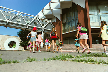 Image showing Happy kids playing at city\'s street in sunny summer\'s day