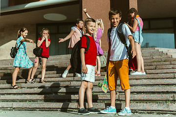 Image showing Happy kids playing at city\'s street in sunny summer\'s day