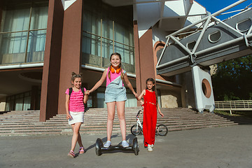 Image showing Happy kids playing at city\'s street in sunny summer\'s day