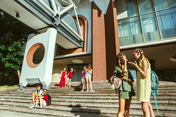 Image showing Happy kids playing at city\'s street in sunny summer\'s day