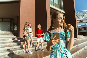 Image showing Happy kids playing at city\'s street in sunny summer\'s day