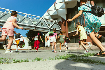 Image showing Happy kids playing at city\'s street in sunny summer\'s day