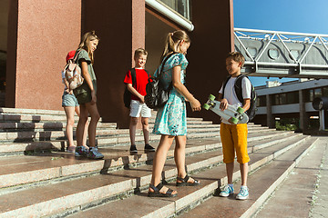 Image showing Happy kids playing at city\'s street in sunny summer\'s day