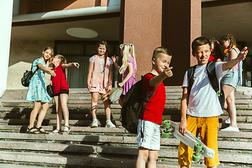 Image showing Happy kids playing at city\'s street in sunny summer\'s day