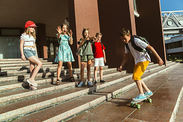 Image showing Happy kids playing at city\'s street in sunny summer\'s day