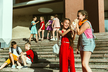 Image showing Happy kids playing at city\'s street in sunny summer\'s day