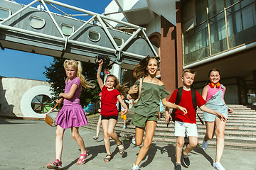 Image showing Happy kids playing at city\'s street in sunny summer\'s day