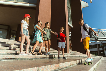 Image showing Happy kids playing at city\'s street in sunny summer\'s day