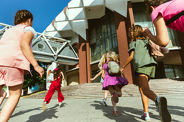 Image showing Happy kids playing at city\'s street in sunny summer\'s day