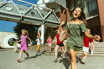 Image showing Happy kids playing at city\'s street in sunny summer\'s day