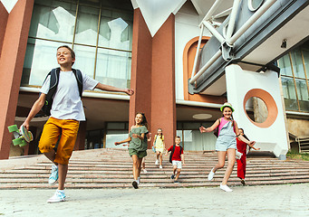 Image showing Happy kids playing at city\'s street in sunny summer\'s day