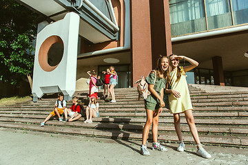 Image showing Happy kids playing at city\'s street in sunny summer\'s day