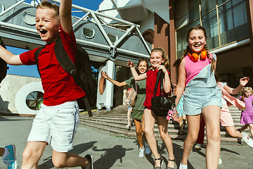 Image showing Happy kids playing at city\'s street in sunny summer\'s day