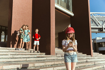 Image showing Happy kids playing at city\'s street in sunny summer\'s day