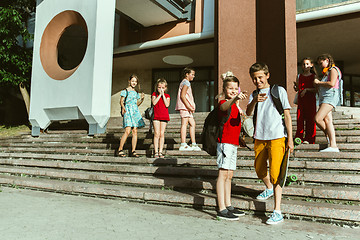 Image showing Happy kids playing at city\'s street in sunny summer\'s day