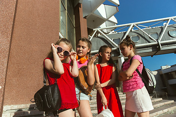 Image showing Happy kids playing at city\'s street in sunny summer\'s day