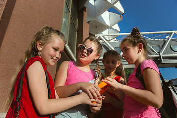 Image showing Happy kids playing at city\'s street in sunny summer\'s day