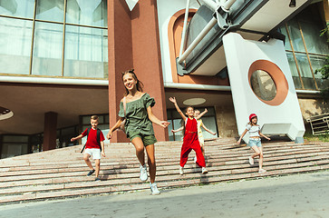 Image showing Happy kids playing at city\'s street in sunny summer\'s day