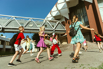 Image showing Happy kids playing at city\'s street in sunny summer\'s day