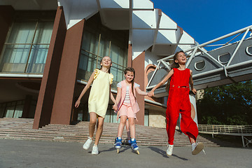 Image showing Happy kids playing at city\'s street in sunny summer\'s day