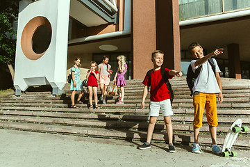 Image showing Happy kids playing at city\'s street in sunny summer\'s day