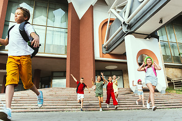 Image showing Happy kids playing at city\'s street in sunny summer\'s day