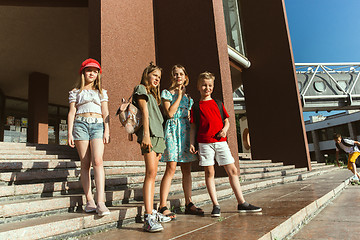 Image showing Happy kids playing at city\'s street in sunny summer\'s day