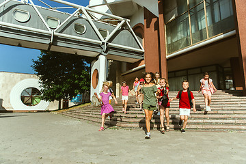 Image showing Happy kids playing at city\'s street in sunny summer\'s day