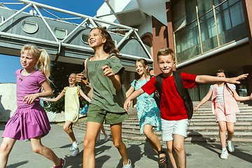 Image showing Happy kids playing at city\'s street in sunny summer\'s day