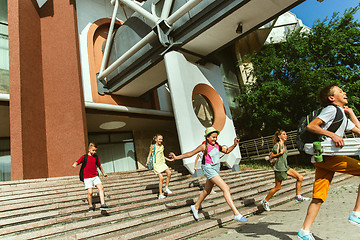 Image showing Happy kids playing at city\'s street in sunny summer\'s day