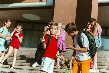 Image showing Happy kids playing at city\'s street in sunny summer\'s day