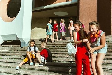 Image showing Happy kids playing at city\'s street in sunny summer\'s day