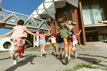 Image showing Happy kids playing at city\'s street in sunny summer\'s day