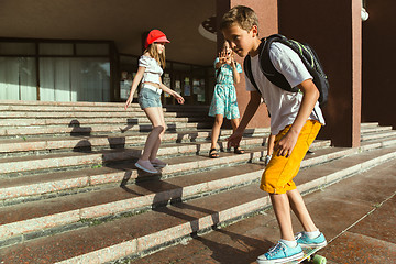 Image showing Happy kids playing at city\'s street in sunny summer\'s day