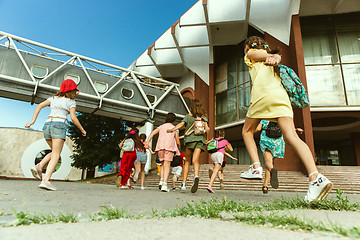 Image showing Happy kids playing at city\'s street in sunny summer\'s day