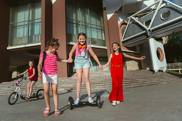 Image showing Happy kids playing at city\'s street in sunny summer\'s day