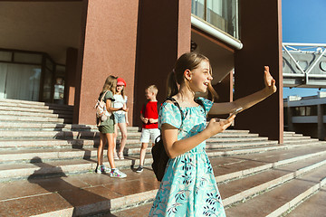 Image showing Happy kids playing at city\'s street in sunny summer\'s day