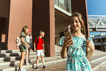 Image showing Happy kids playing at city\'s street in sunny summer\'s day