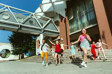 Image showing Happy kids playing at city\'s street in sunny summer\'s day