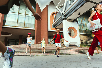 Image showing Happy kids playing at city\'s street in sunny summer\'s day