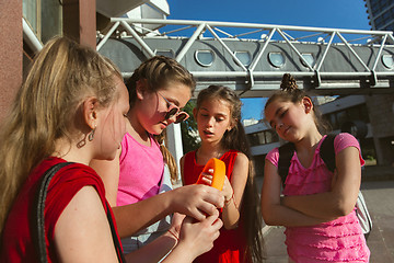 Image showing Happy kids playing at city\'s street in sunny summer\'s day