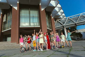 Image showing Happy kids playing at city\'s street in sunny summer\'s day