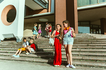 Image showing Happy kids playing at city\'s street in sunny summer\'s day