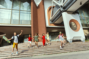 Image showing Happy kids playing at city\'s street in sunny summer\'s day