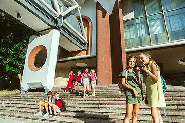 Image showing Happy kids playing at city\'s street in sunny summer\'s day