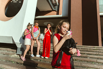 Image showing Happy kids playing at city\'s street in sunny summer\'s day