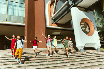 Image showing Happy kids playing at city\'s street in sunny summer\'s day