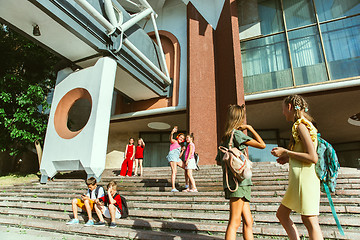 Image showing Happy kids playing at city\'s street in sunny summer\'s day