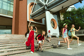 Image showing Happy kids playing at city\'s street in sunny summer\'s day