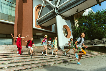 Image showing Happy kids playing at city\'s street in sunny summer\'s day